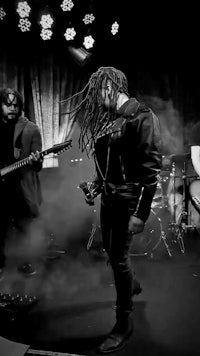 a black and white photo of a band on stage
